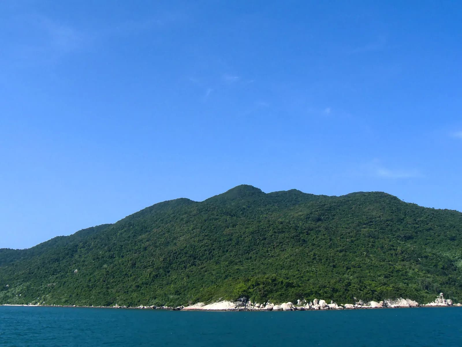 The forested spine of Cu Lao Cham rising from the sea