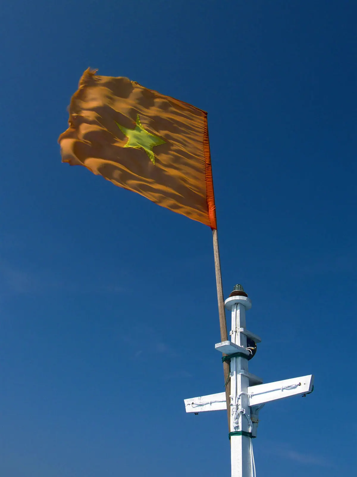 Vietnamese flag flying from a boat mast off Cu Lao Cham