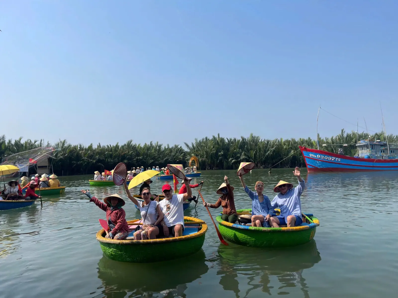 Guests paddling basket boats through the Bay Mau coconut palm water forest near Hoi An