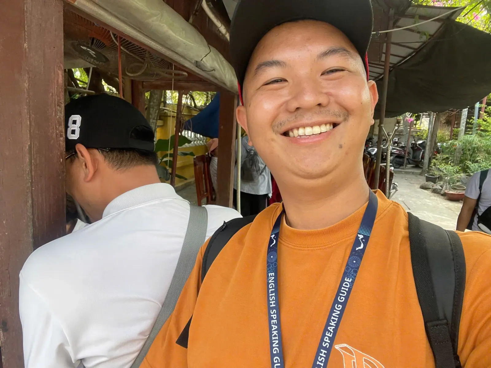 Tom taking a selfie with a guest at a riverside restaurant during a Hoi An private tour