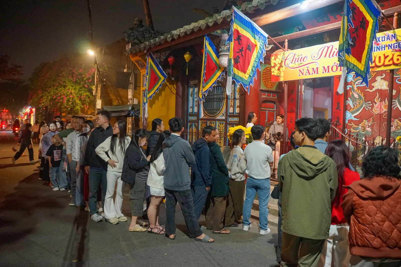 Queue of visitors waiting to enter the lantern-lit temple on the first night of the Lunar New Year