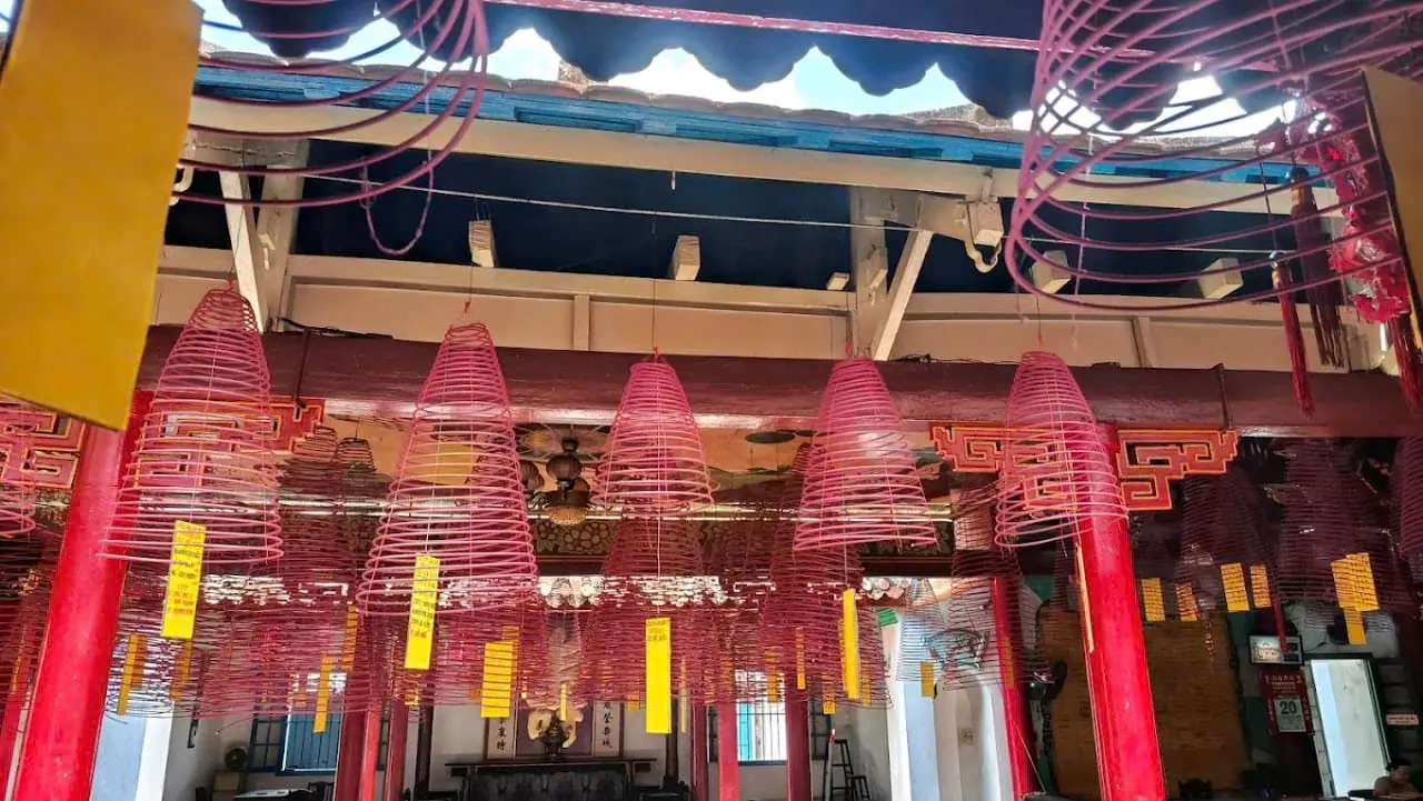 Inner courtyard of the Phuc Kien Assembly Hall, with incense coils hanging above the walkway
